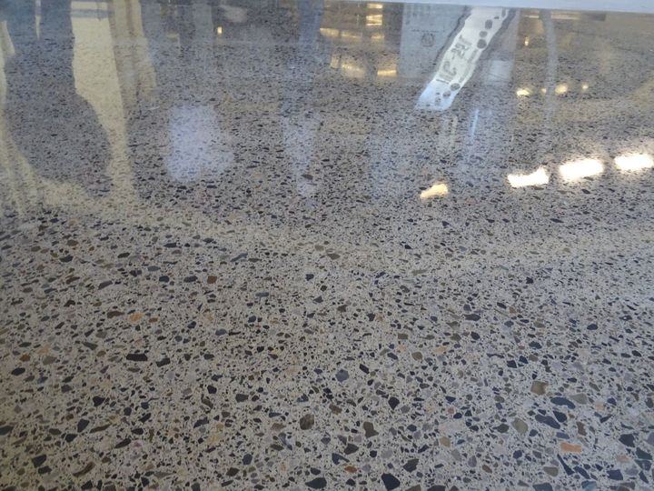 Ayna parlaklığında beton zemin: agrega açık, güçlü yansıma